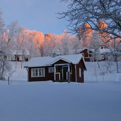 Röd fjällstuga i vackert vinterlandskap – Grövelsjöfjällen